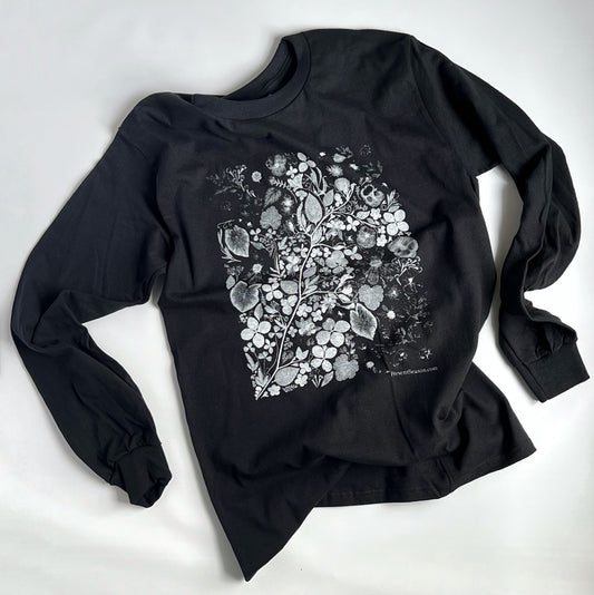 A black long sleeved tshirt with a white and gray rectangular print of an art scene made from pressed flowers.